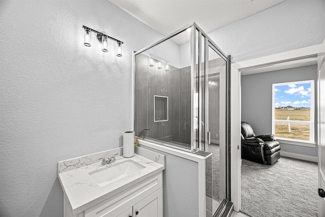 bathroom featuring vanity and a shower with door