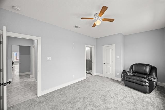 living area with carpet flooring and ceiling fan