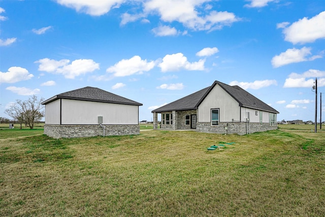 rear view of house featuring a yard