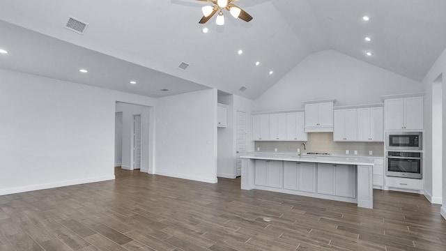 21219 Palm Arbor Dr, Cypress, TX 77433 - kitchen with oven, built in microwave, a ceiling fan, white cabinetry, and light countertops