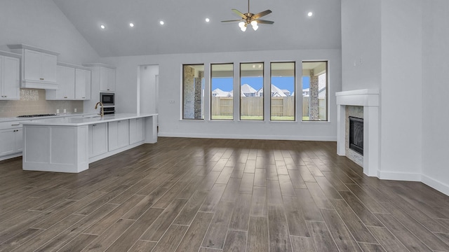 21219 Palm Arbor Dr, Cypress, TX 77433 - kitchen with light countertops, high vaulted ceiling, built in microwave, open floor plan, and a ceiling fan