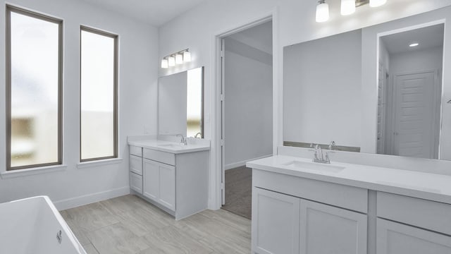 21219 Palm Arbor Dr, Cypress, TX 77433 - full bath featuring two vanities, baseboards, and a soaking tub