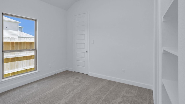 21219 Palm Arbor Dr, Cypress, TX 77433 - spare room featuring carpet flooring, baseboards, and lofted ceiling