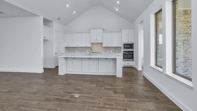 21219 Palm Arbor Dr, Cypress, TX 77433 - kitchen with oven, built in microwave, light countertops, white cabinetry, and backsplash