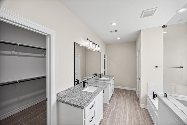 bathroom with a tub and vanity