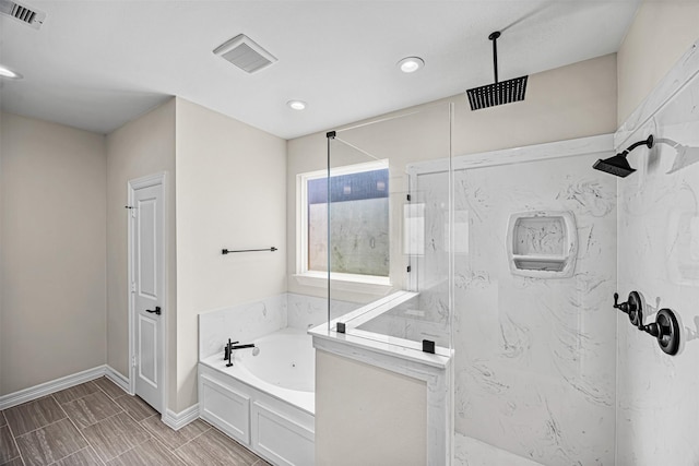 bathroom featuring separate shower and tub