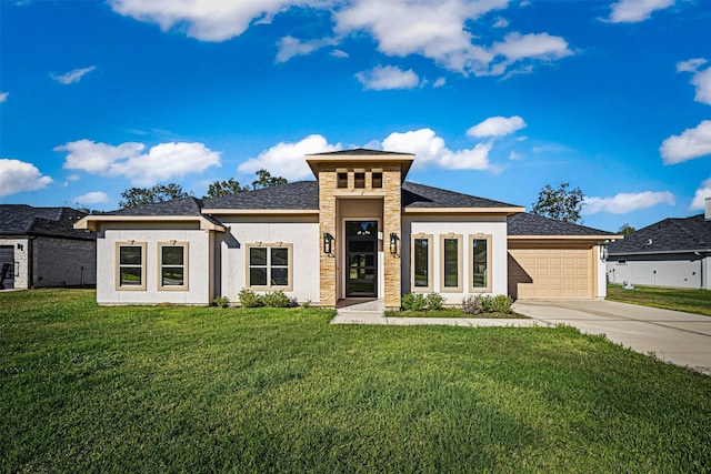 prairie-style house featuring a front lawn and a garage