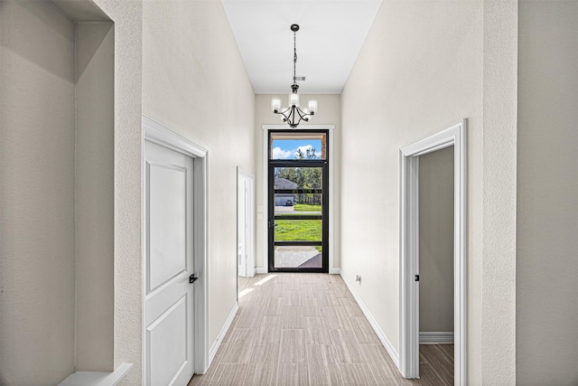 foyer featuring an inviting chandelier and light hardwood / wood-style flooring