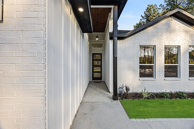 doorway to property with brick siding