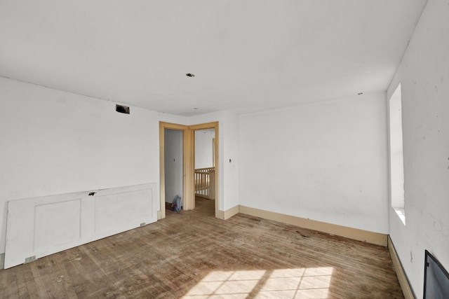 unfurnished room with wood-type flooring