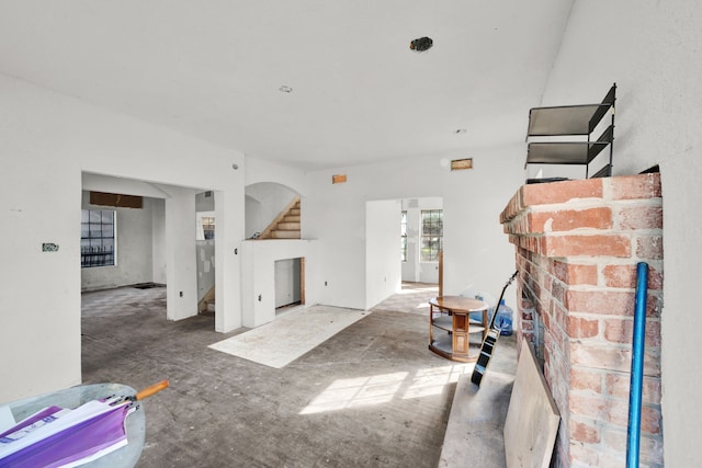 living room with a brick fireplace