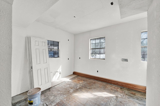 unfurnished room featuring plenty of natural light