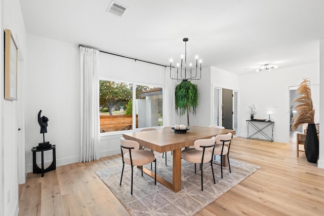 dining room featuring an inviting chandelier and light hardwood / wood-style flooring