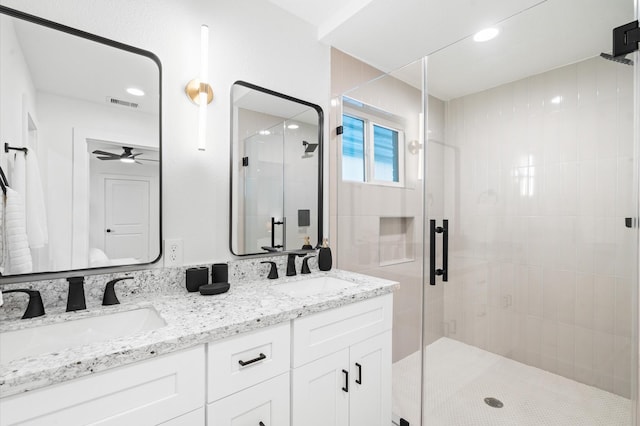 bathroom with an enclosed shower and vanity