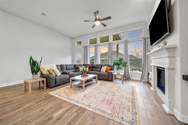 living room featuring ceiling fan and light wood-type flooring