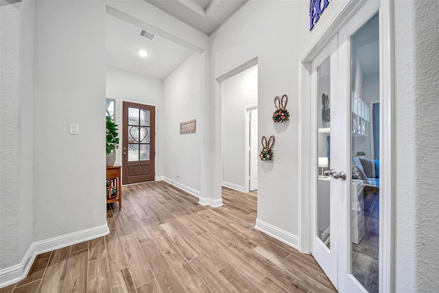 entryway featuring light hardwood / wood-style floors and french doors