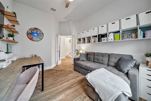 living room with light hardwood / wood-style floors and ceiling fan