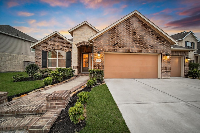 view of front of home with a garage and a yard