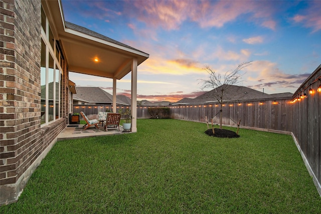 yard at dusk with a patio area