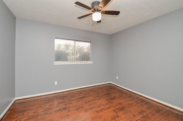 unfurnished room with ceiling fan, baseboards, and wood finished floors