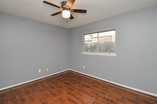 unfurnished room with ceiling fan, a textured ceiling, baseboards, and wood finished floors