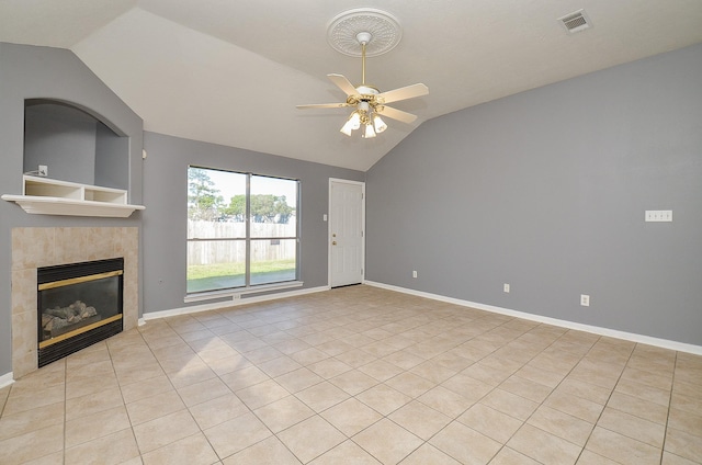 unfurnished living room with lofted ceiling, visible vents, a ceiling fan, and a tile fireplace