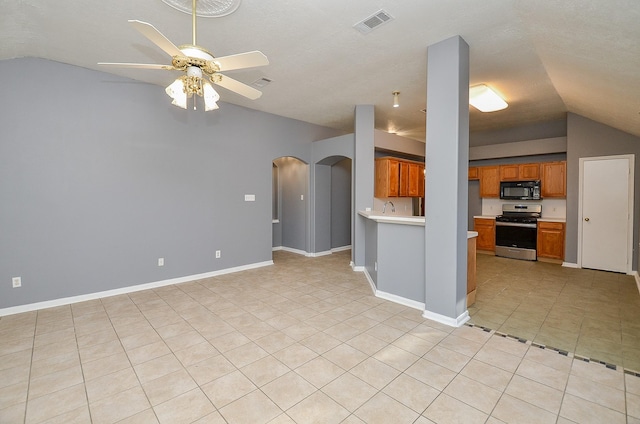 unfurnished living room featuring baseboards, visible vents, arched walkways, a ceiling fan, and lofted ceiling