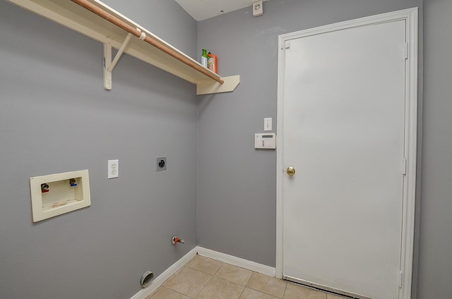 washroom featuring washer hookup, light tile patterned flooring, electric dryer hookup, laundry area, and baseboards