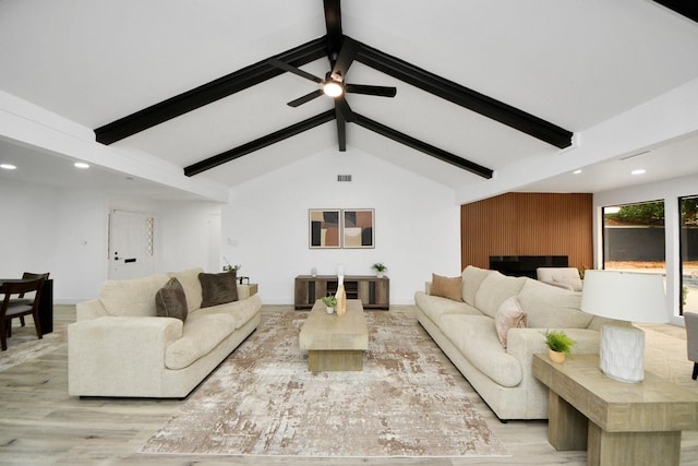 living room featuring ceiling fan, light hardwood / wood-style floors, and lofted ceiling with beams