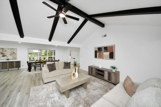 living room featuring beam ceiling, high vaulted ceiling, ceiling fan, and light hardwood / wood-style flooring