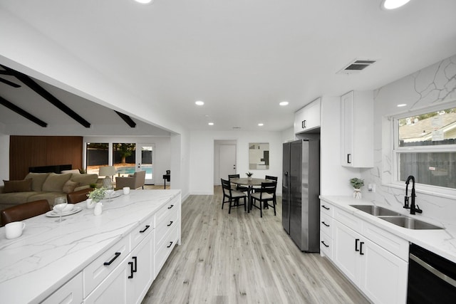 kitchen featuring light hardwood / wood-style flooring, dishwasher, stainless steel refrigerator with ice dispenser, sink, and white cabinetry