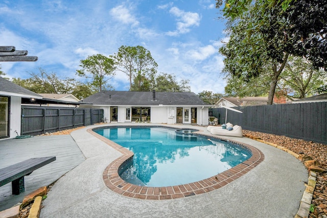 view of pool featuring a deck and an in ground hot tub