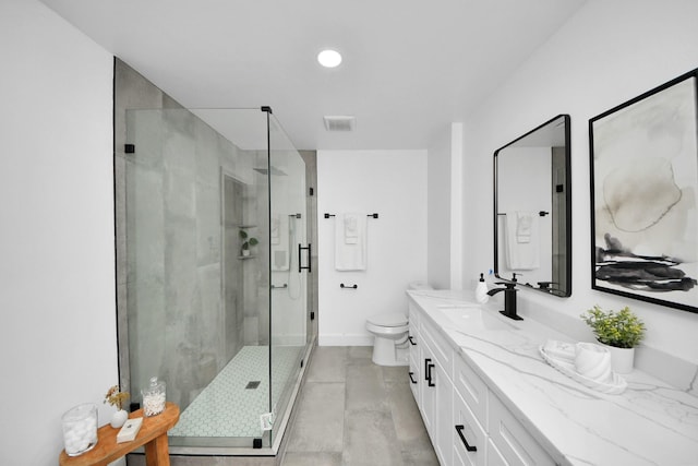 bathroom with toilet, a shower with door, and vanity