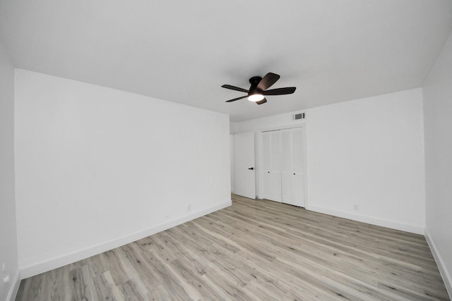 unfurnished bedroom featuring a closet, ceiling fan, and light hardwood / wood-style flooring