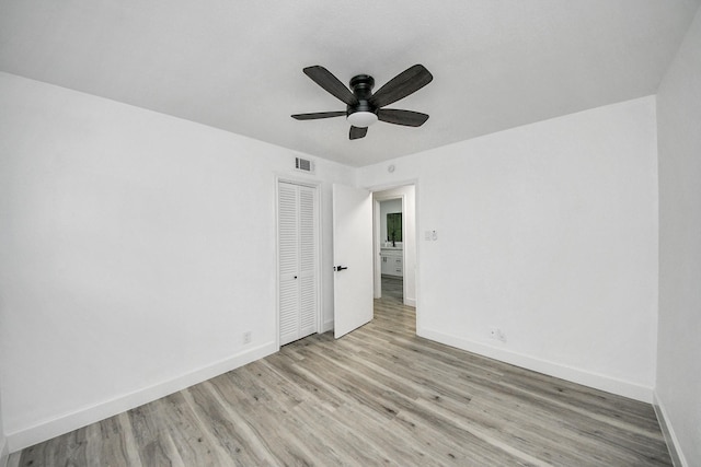 spare room with light hardwood / wood-style flooring and ceiling fan