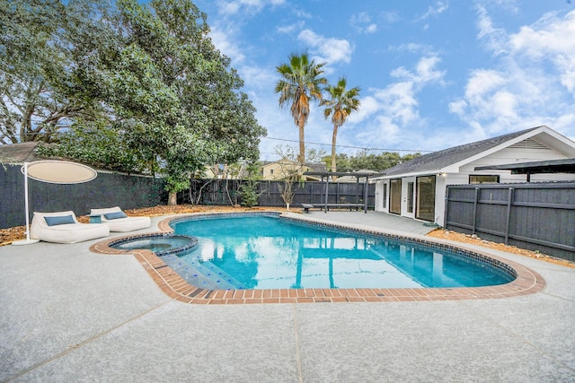 view of pool with a patio and an in ground hot tub