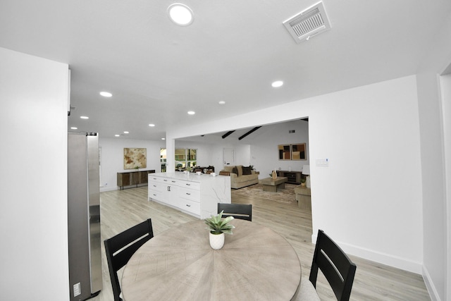 dining room featuring light hardwood / wood-style flooring and a barn door