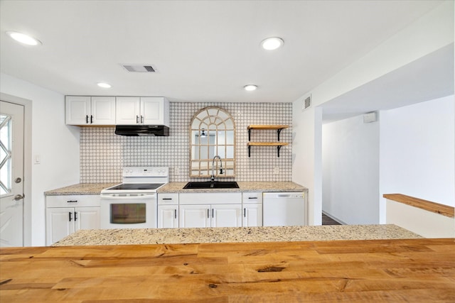 kitchen with sink, white appliances, white cabinets, and wooden counters