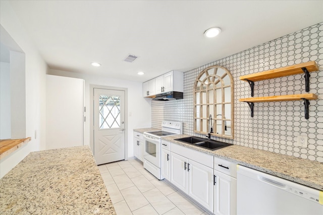 kitchen with white appliances, white cabinetry, and light stone counters