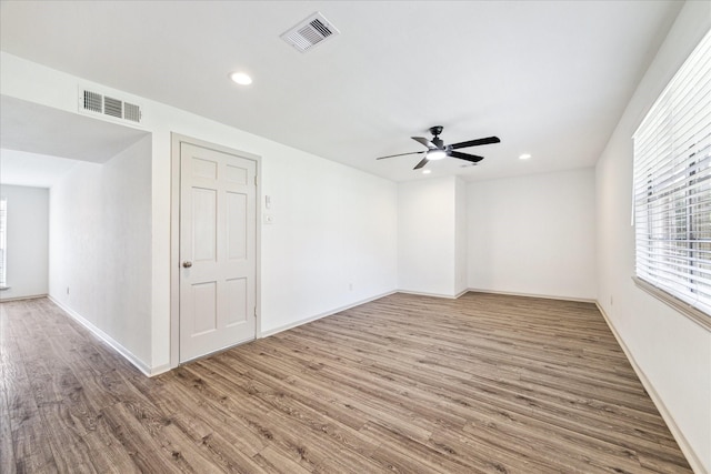 unfurnished room with hardwood / wood-style floors and ceiling fan