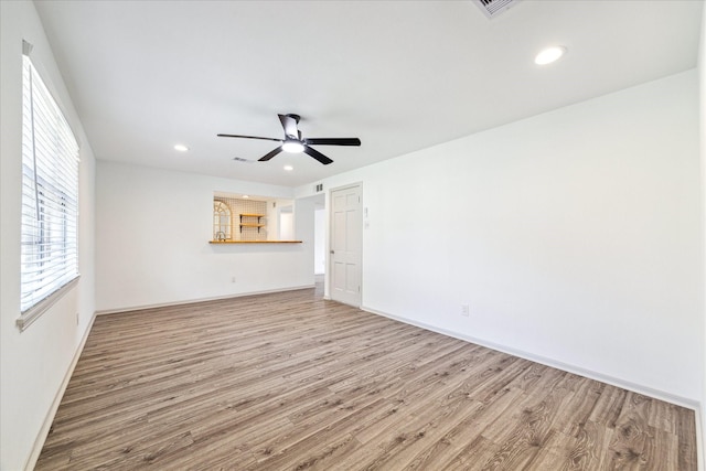 spare room with ceiling fan and wood-type flooring