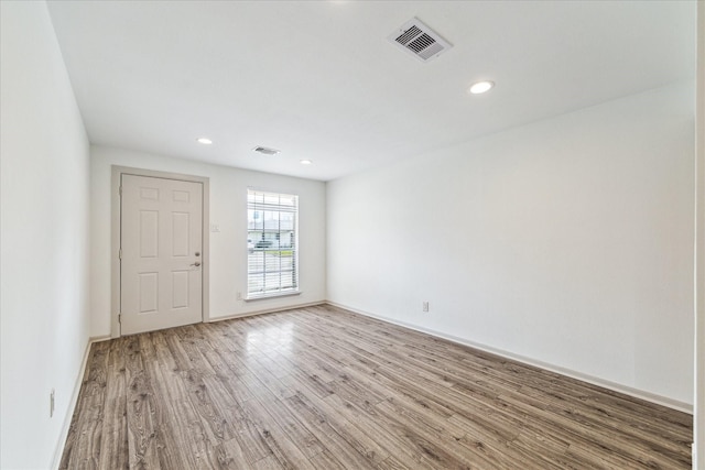 spare room featuring wood-type flooring