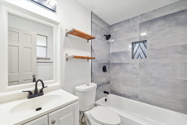 full bathroom with toilet, vanity, and tiled shower / bath