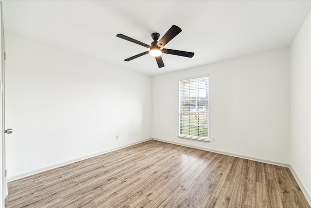 empty room with ceiling fan and light hardwood / wood-style floors