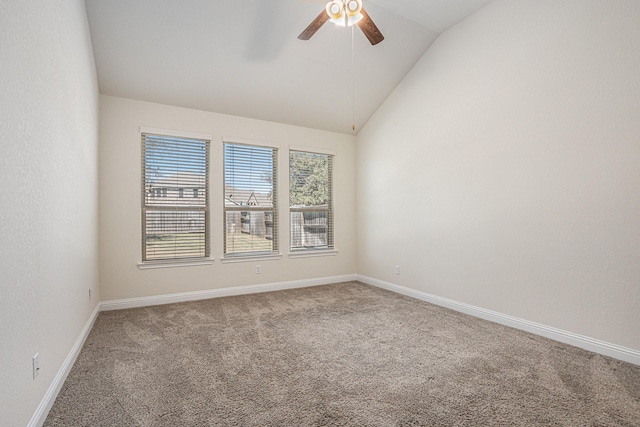 unfurnished room featuring ceiling fan, carpet, baseboards, and vaulted ceiling