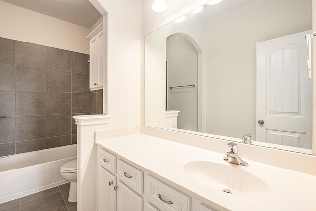 bathroom with shower / washtub combination, tile patterned flooring, vanity, and toilet