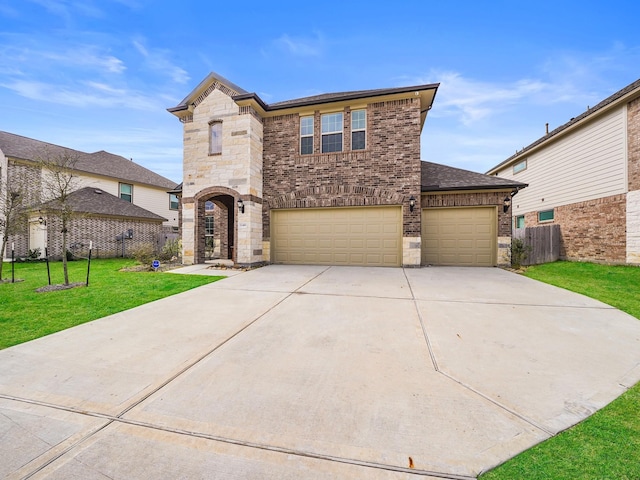 view of front facade featuring a front yard and a garage