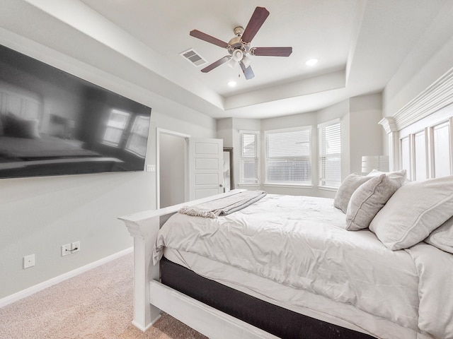 bedroom featuring a tray ceiling, ceiling fan, and carpet floors