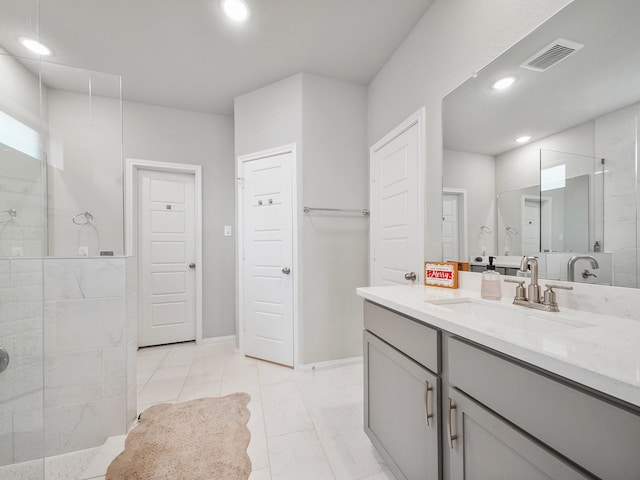 bathroom with vanity and tiled shower