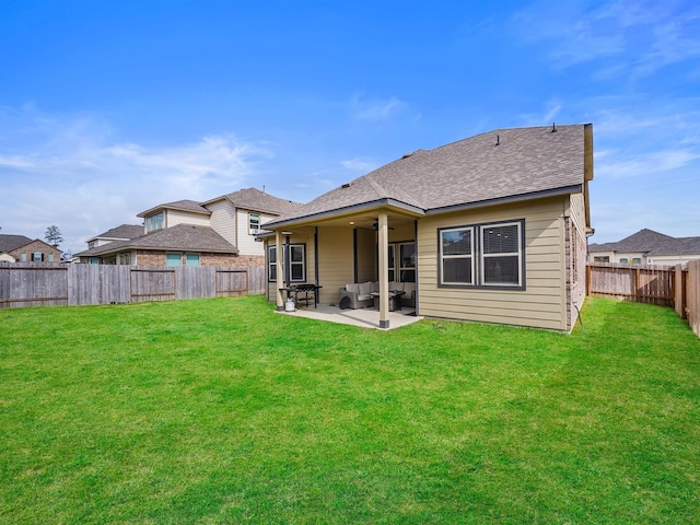 rear view of house featuring a lawn and a patio area